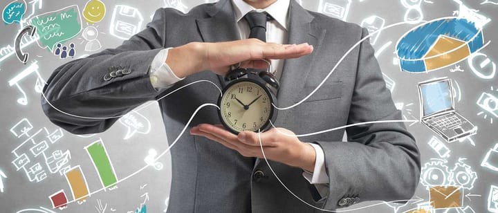 A man in a suit holding an alarm clock. From it flow all kinds of excel-like graphs.